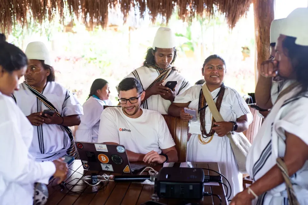 An educator teaching Bitcoin to a community